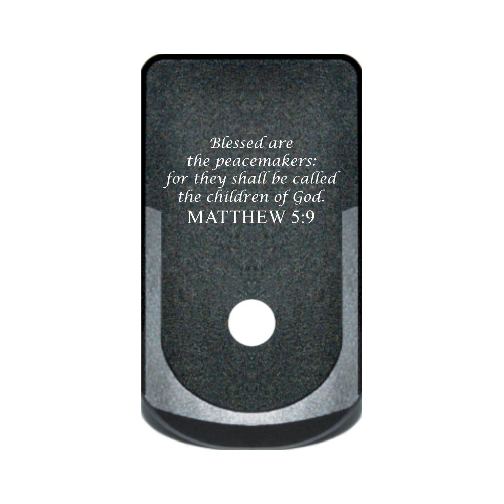Matthew 5:9 laser engraved on a grip extended magazine base plate for Glock 43
